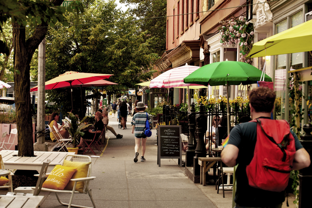 a person with a red backpack walking through Carroll Gardens after leaving their Carroll Gardens apartment rental